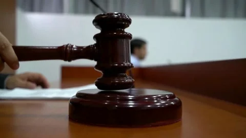 Judge hand hitting hammer on sounding block in courtroom Stock Footage 333485839