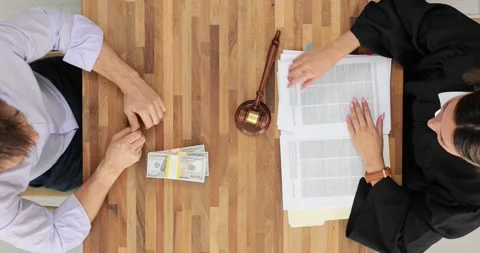 Judge refuses to take a bribe from a client at the table in the courtroom, top Stock Footage 274128778