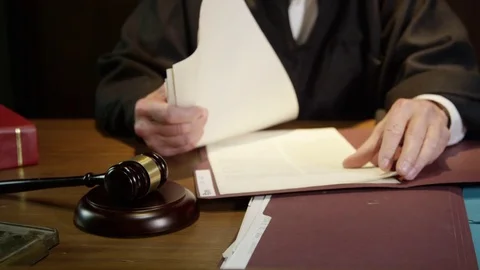 Judge wide angle looking through papers in court case Video stock 72965932