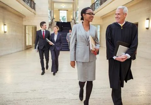 Judges and lawyers walking through courthouse Stock Photos
