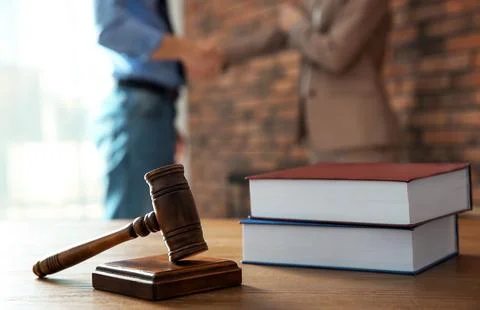 Judge's gavel and notary with client on background. Law and justice concept Stock Photos