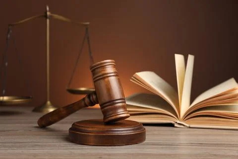 Judge's gavel with sound block, scales of justice and book on wooden table ag Stock Photos