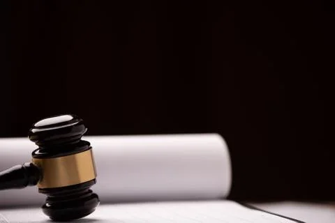 Judge`s gavel with white paper on the background. Stock Photos