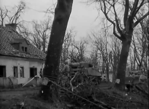 JUELICH, GERMANY - 1945: Blown-out window frames - Tank passes a collapsed roof Stock Footage 344599412