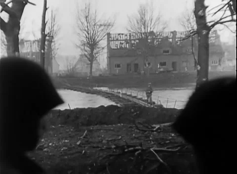 JUELICH, GERMANY - 1945: Waterside view - Ruin stands beyond earth bank Stock Footage 344599092