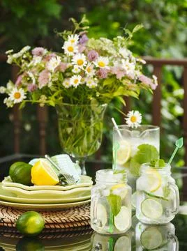 Jug and jars of Lemonade on a table in the garden Stock Photos