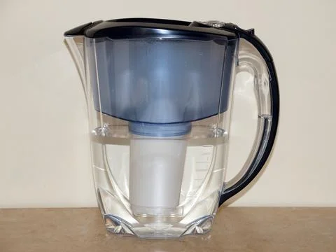 Jug drinking water filter on the table close-up Stock Photos