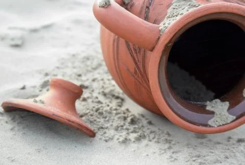 Jug in the sand. Stock Photos