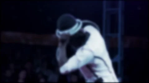 Juggler performing intricate hat manipulation routine on stage under spotlights Stock Footage 344847050