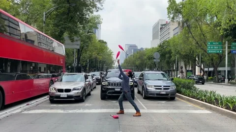 Juggler performs in Paseo de la Reforma avenue, Mexico City 4K Stock Footage 160368563