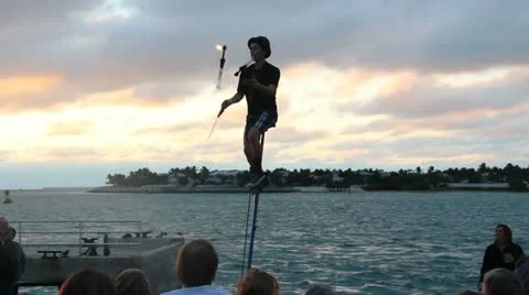 Juggler on unicycle at sunset Stock Footage 20585936