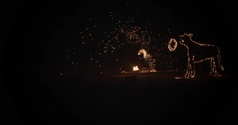 Juggler waving fire particles in the air Stock Footage 167058916