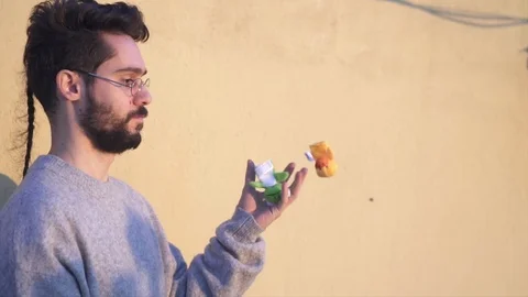 Juggler, Young Man Juggling with three toys, in Slow Motion video shot with g Stock Footage 106722386