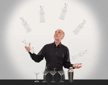 Juggling bartender showing off his juggling skills Stock Photos