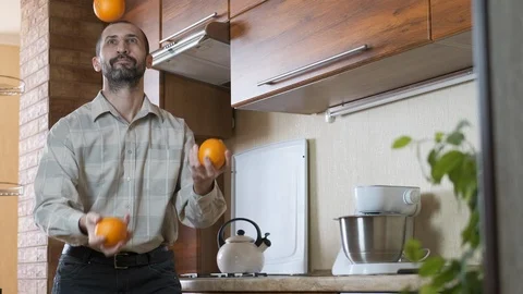 Juggling in the kitchen. Stock Footage 107555193