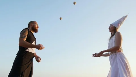 Juggling performance against the blue sky shaky footage slow motion Stock Footage 99532450