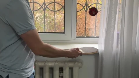 Juggling a ping pong ball with a paddle Stock Footage 335074405