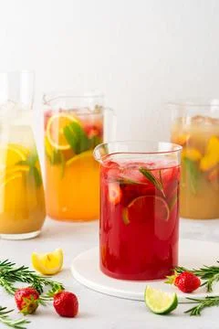 Jugs of refreshing fruit drinks with fruit wedges Stock Photos