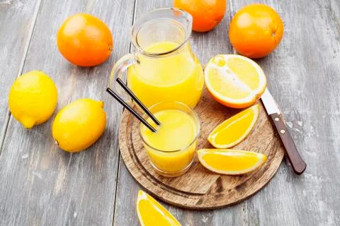 Juice and oranges Stock Photos