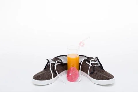 Juice and sneakers. Stock Photos