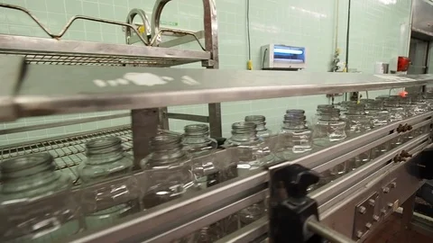 Juice bottling plant empty bottles on conveyor Video stock 124216585