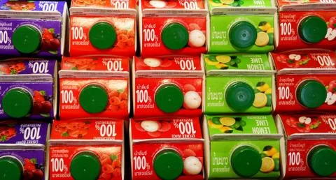 Juice Boxes stacked on Shelf with Thai and English Words Stock Photos
