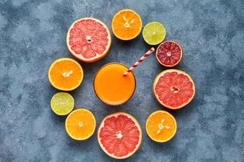Juice with citrus fruit, grapefruit on blue background. Top view, selective Stock Photos