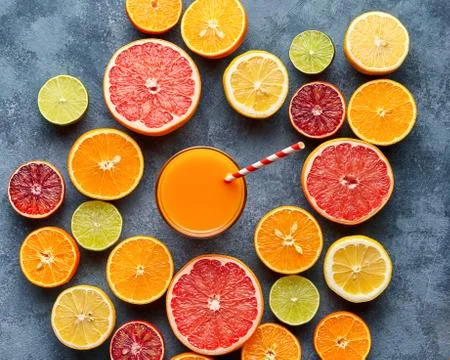 Juice with citrus fruit, grapefruit, orange on blue background. Top view Stock Photos