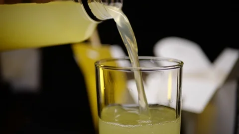 Juice, drink is poured in a slow mo in a glass Stock Footage 127541927
