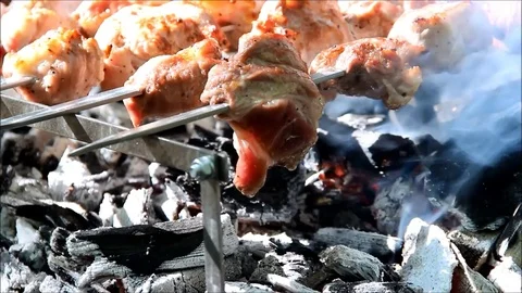 Juice dripping from a piece of barbecue into hot coals Stock Footage 77861107