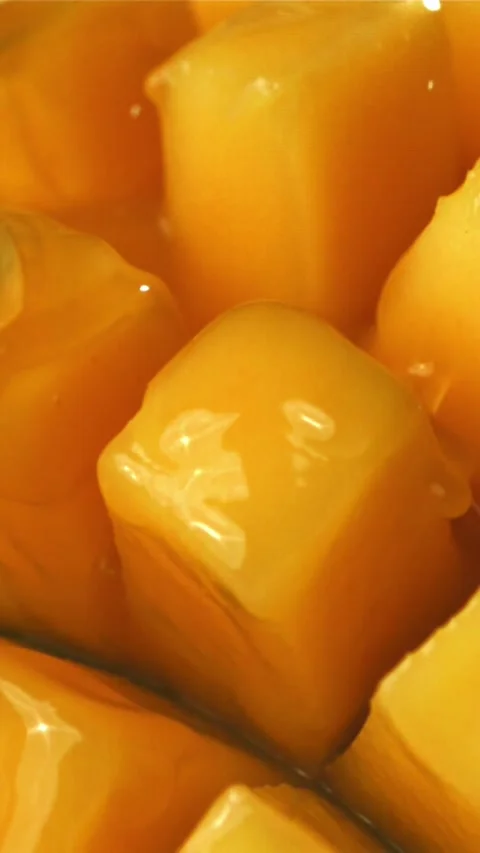 The juice flows through the sliced mango fruit. Filmed on a high-speed camera at 스톡 동영상 335305556