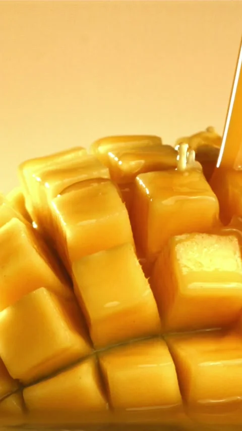 The juice flows through the sliced mango fruit. Filmed on a high-speed camera at 스톡 동영상 335307353