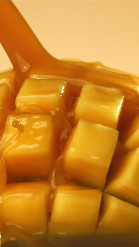 The juice flows through the sliced mango fruit. Filmed on a high-speed camera at 스톡 동영상 335311643
