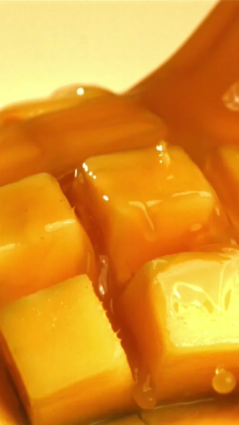 The juice flows through the sliced mango fruit. Filmed on a high-speed camera at 스톡 동영상 335313649