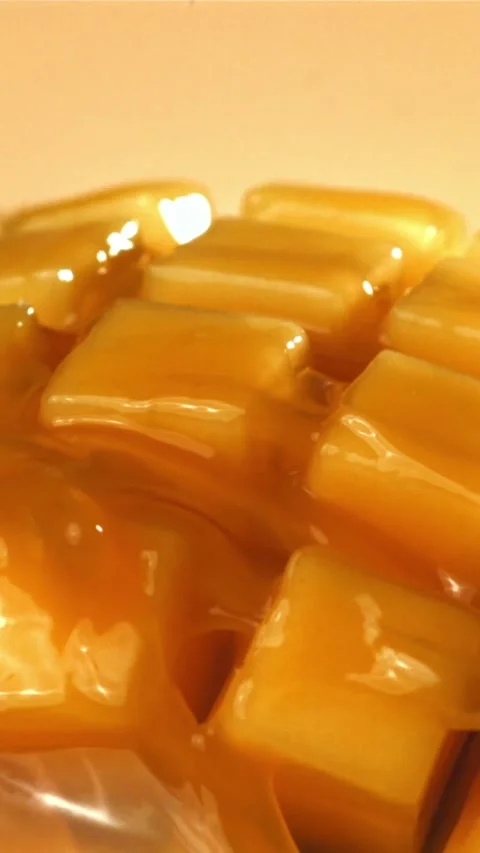 The juice flows through the sliced mango fruit. Filmed on a high-speed camera at 스톡 동영상 335320987
