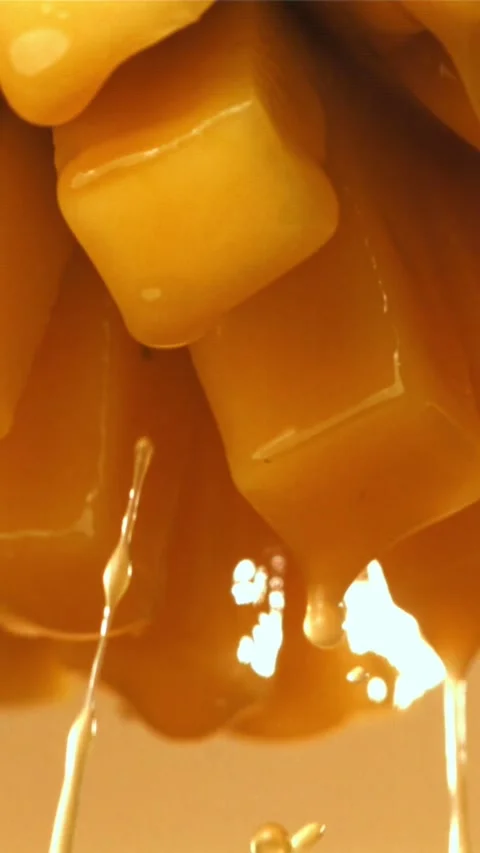 The juice flows through the sliced mango fruit. Filmed on a high-speed camera at Stock Footage 335323174