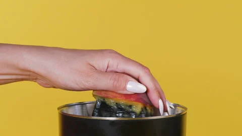 Juice from fruit using a juicer. Fresh juice with pulp, natural drink. Close up. Stock Footage 135603718