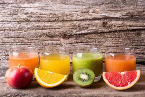 Juice with fruits ( kiwi , grapefruit , apple & orange ) Stock Photos