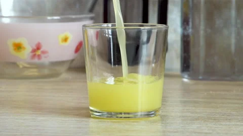 Juice in a glass on the table Video stock 196214753