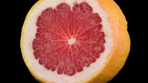 Juice grapefruit isolated on black background. 4K UHD video Stock Footage 154228880