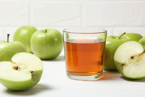 Juice from green apples on the table. Photos
