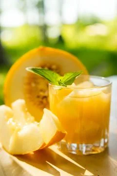 The juice of melon with mint in a glass jar on the table.Hami melon Stock Photos