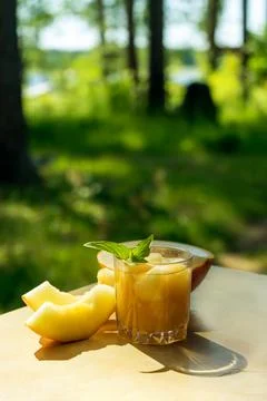 The juice of melon with mint in a glass jar on the table.Hami melon Stock Photos
