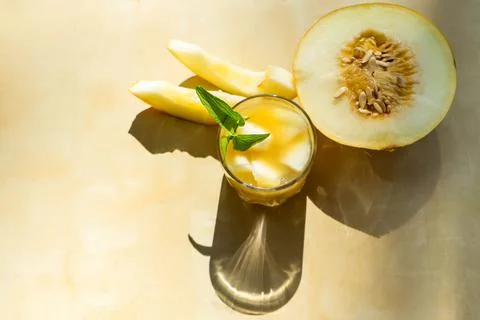 The juice of melon with mint in a glass jar on the table.Hami melon Stock Photos