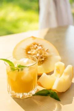 The juice of melon with mint in a glass jar on the table.Hami melon Stock Photos