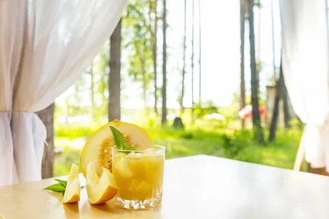 The juice of melon with mint in a glass jar on the table.Hami melon Stock Photos