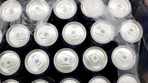 Juice or beer in an iron cans in a supermarket or warehouse. Packaged drinks. Wh Stock Footage 275337392
