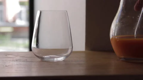 Juice is poured into a glass Видео 58861289