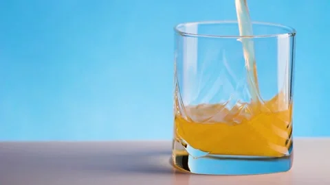 Juice is poured into a glass Stock Footage 134908387