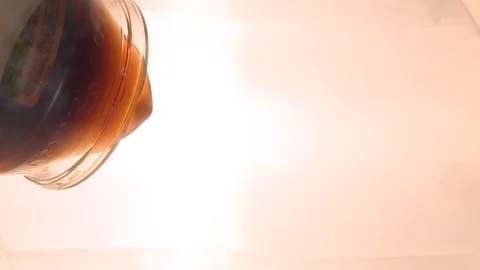 The juice is poured into a glass, the view from the bottom of the glass. Bottom Stock Footage 101284921